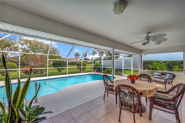 view of pool with ceiling fan, a patio, and glass enclosure