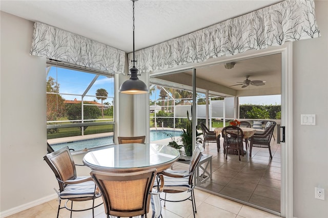 dining room featuring light tile patterned floors, a textured ceiling, and ceiling fan