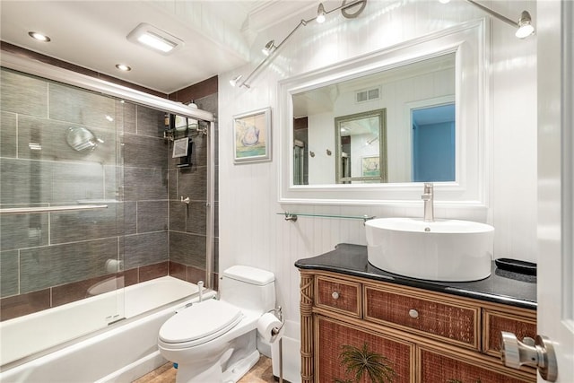 full bath featuring visible vents, shower / bath combination with glass door, vanity, and toilet