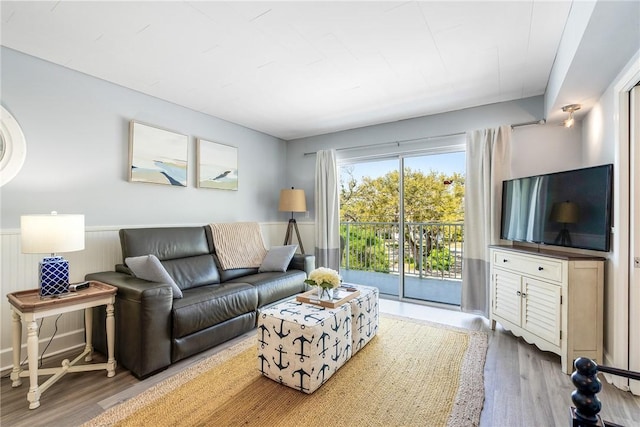 living room featuring wainscoting and wood finished floors