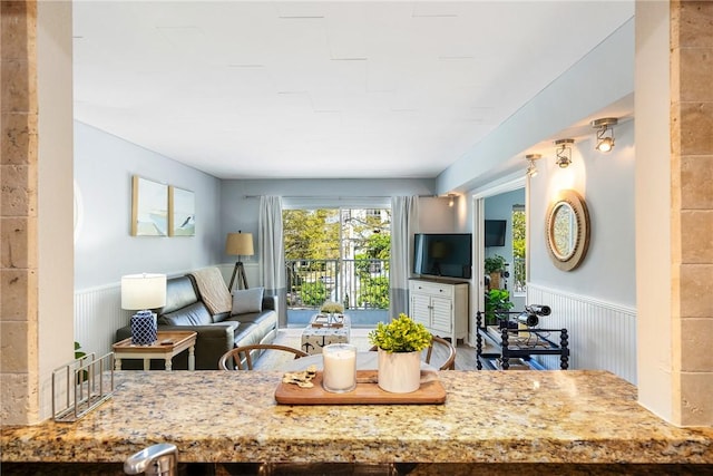 kitchen with light stone counters and wainscoting