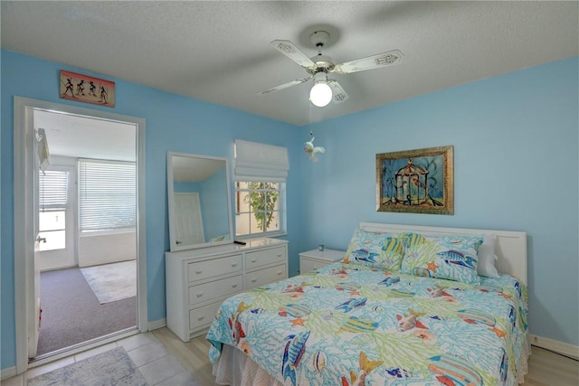 8520 US Highway 1 Unit 11E, Micco, FL 32976 - bedroom with a textured ceiling, ceiling fan, baseboards, and multiple windows