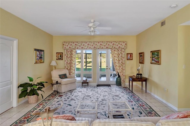 living area featuring ceiling fan and light tile patterned floors