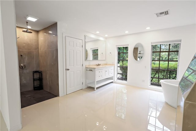 6235 4th St, Vero Beach, FL 32968 - full bathroom with a tile shower, vanity, tile patterned flooring, a freestanding tub, and recessed lighting