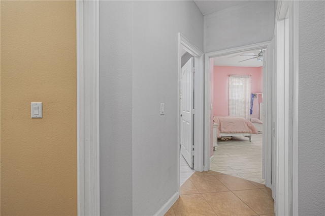 hall with light tile patterned floors