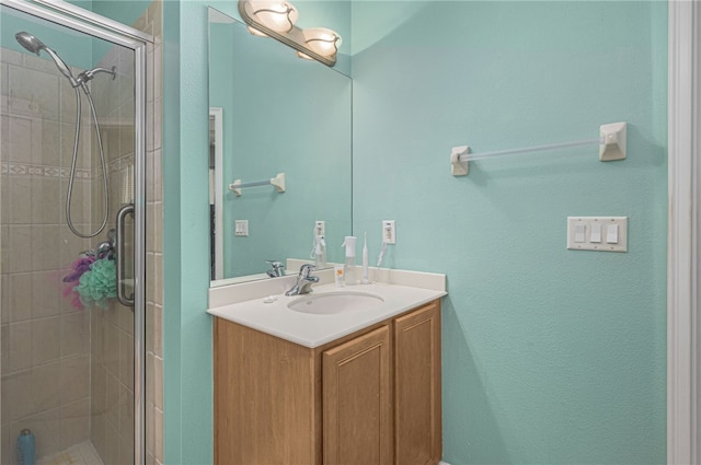 bathroom featuring vanity and a shower with shower door