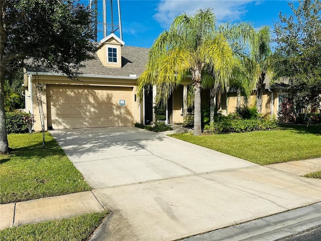 view of front of house featuring a garage and a front lawn