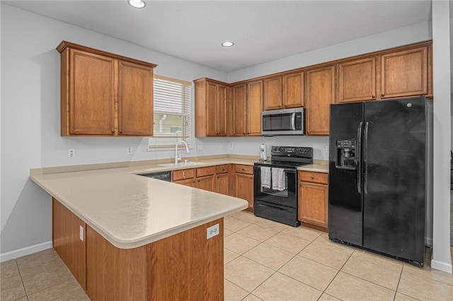 kitchen featuring light tile patterned floors, kitchen peninsula, sink, and black appliances