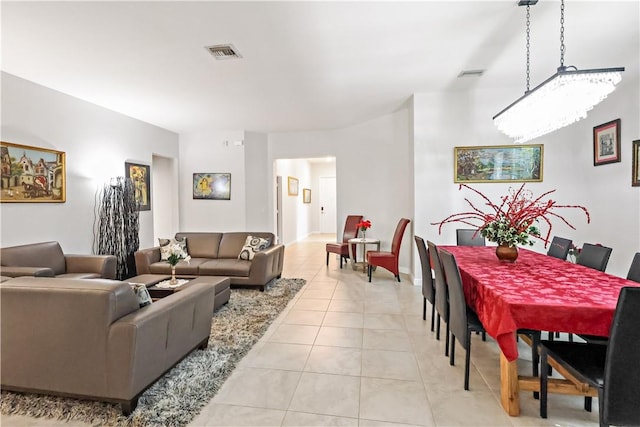 tiled living room featuring a chandelier