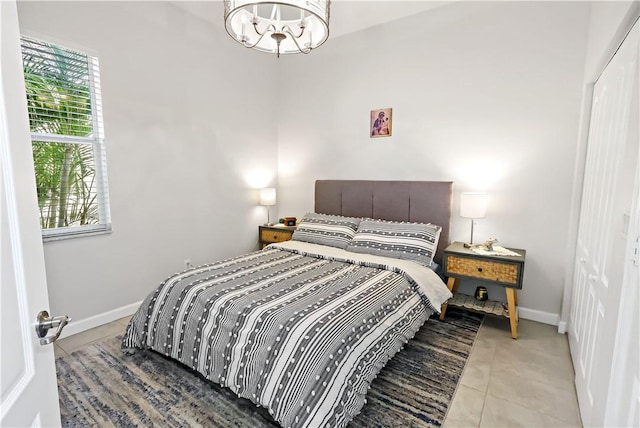 tiled bedroom featuring a chandelier