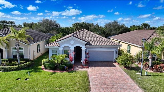 mediterranean / spanish-style house featuring a front lawn and a garage