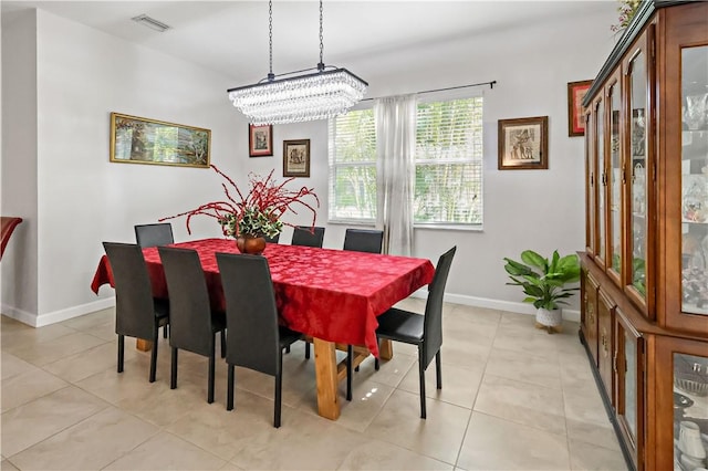 tiled dining area with a chandelier