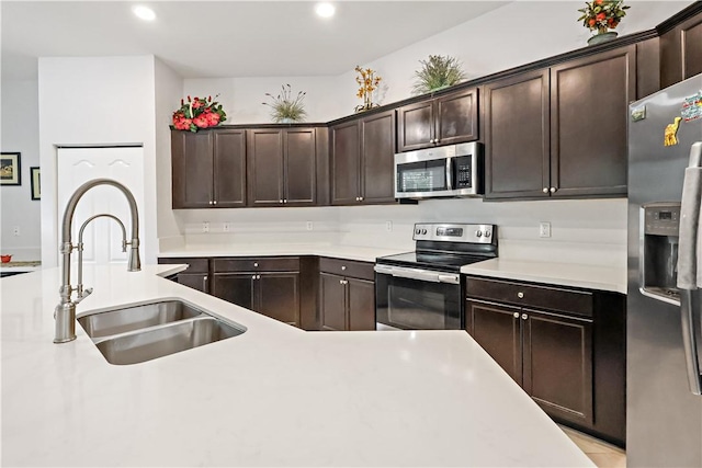 kitchen featuring dark brown cabinets, sink, and stainless steel appliances