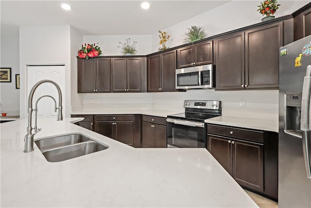 kitchen with dark brown cabinets, sink, and stainless steel appliances