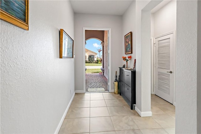 entryway with light tile patterned flooring