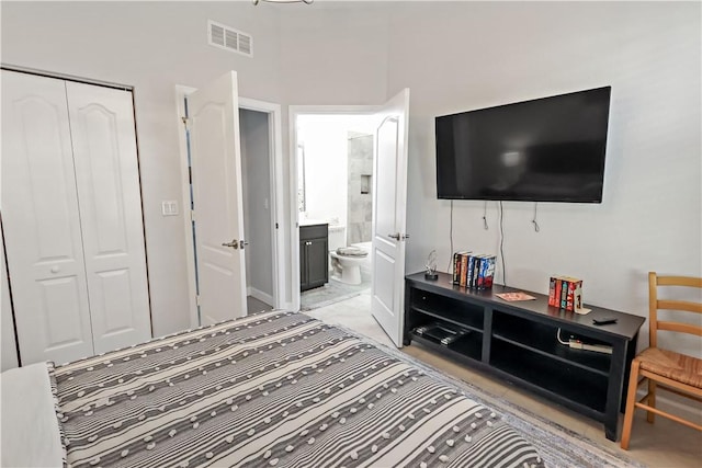 bedroom featuring ensuite bath and a closet