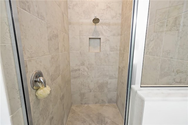 bathroom featuring a shower with door