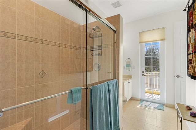 bathroom with a shower with door, tile patterned flooring, and toilet