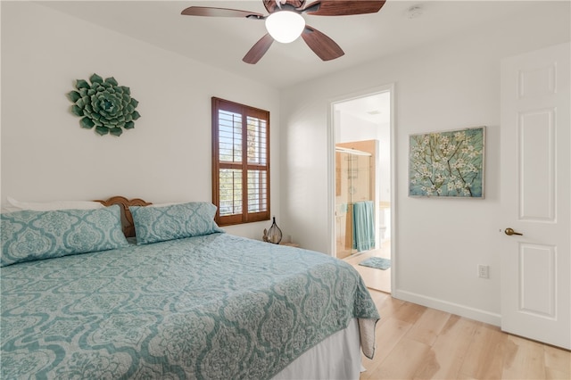 bedroom with light wood-type flooring, ceiling fan, and ensuite bath