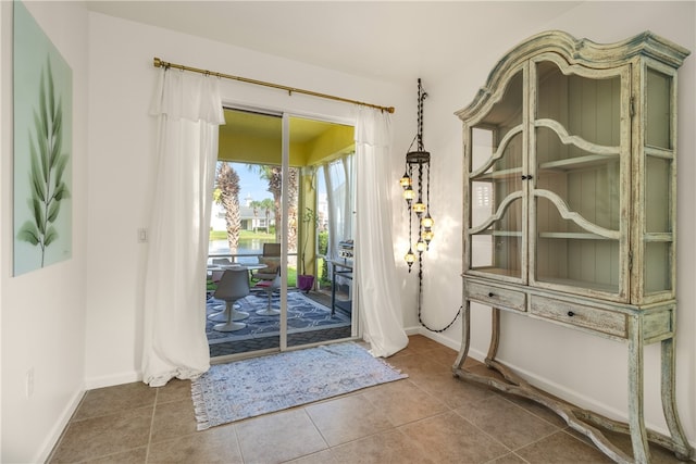 doorway to outside featuring tile patterned floors