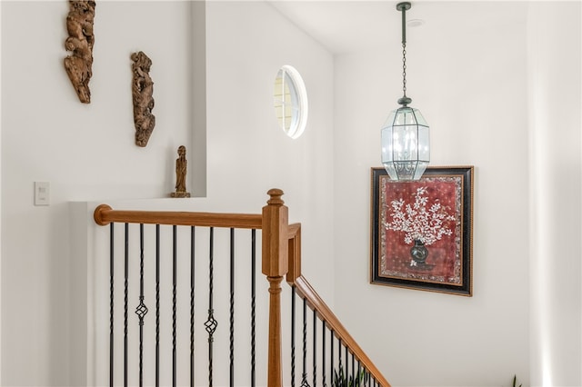 stairs featuring an inviting chandelier