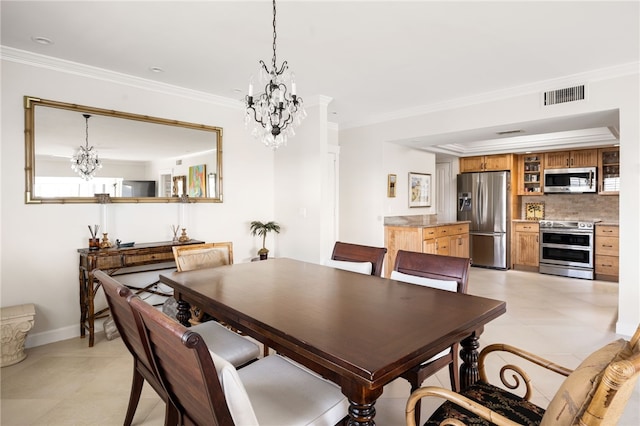 dining area with light tile patterned floors, ornamental molding, and an inviting chandelier