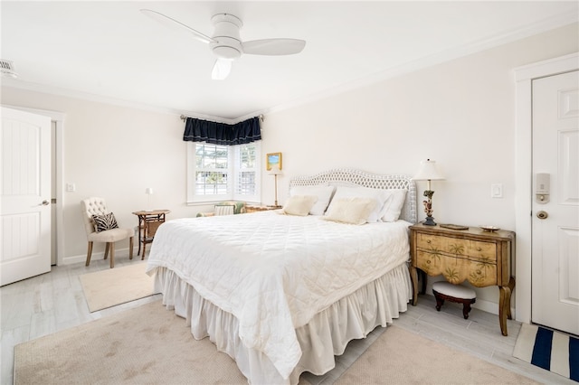 bedroom with ceiling fan, crown molding, and light wood-type flooring