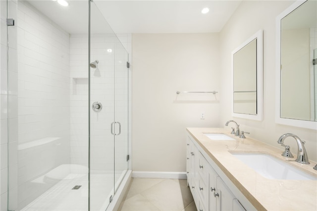 bathroom with tile patterned floors, vanity, and walk in shower