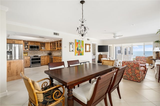 dining room featuring sink, light tile patterned floors, ceiling fan with notable chandelier, and ornamental molding