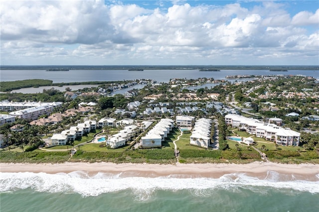 bird's eye view with a water view and a view of the beach