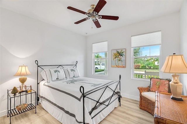 bedroom with light hardwood / wood-style floors and ceiling fan