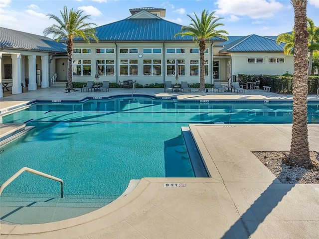 view of swimming pool featuring a patio area