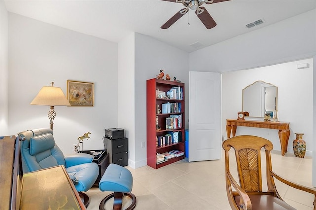 living area with ceiling fan and light tile patterned floors