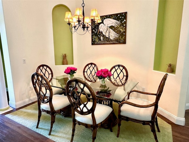 dining room featuring hardwood / wood-style floors and a notable chandelier