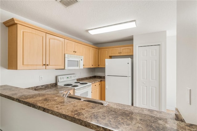 kitchen featuring light brown cabinets, sink, white appliances, and a textured ceiling