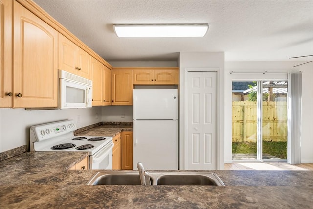 kitchen featuring a textured ceiling, white appliances, sink, and light brown cabinetry