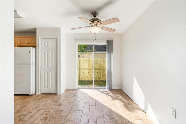 doorway to outside featuring ceiling fan and light wood-type flooring