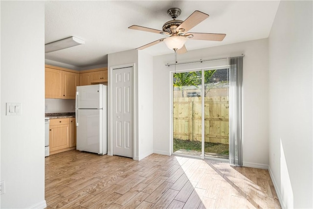 kitchen with light brown cabinetry, white appliances, light hardwood / wood-style flooring, and ceiling fan