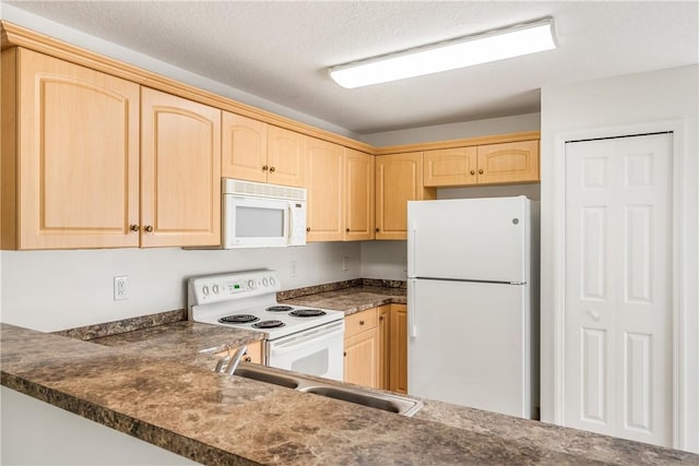 kitchen featuring light brown cabinets, white appliances, a textured ceiling, and sink