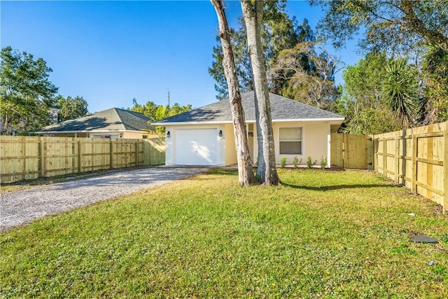 single story home with a front yard and a garage