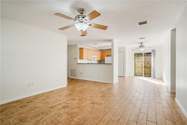 unfurnished living room with ceiling fan and light wood-type flooring