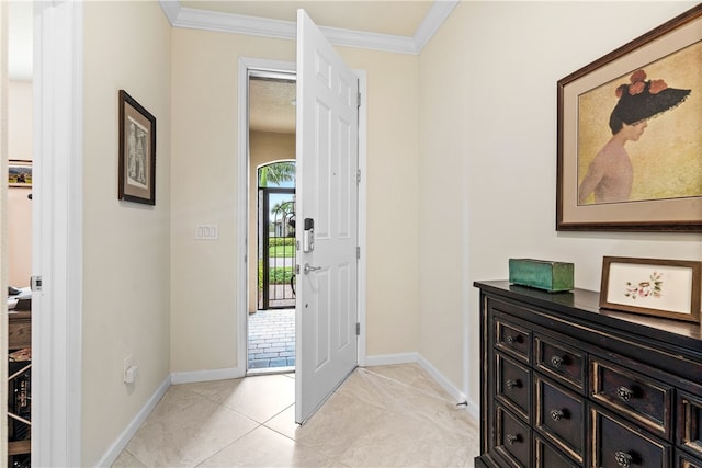 tiled foyer entrance with crown molding