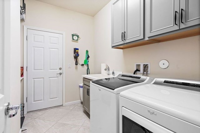 laundry room with cabinets, separate washer and dryer, light tile patterned flooring, and sink