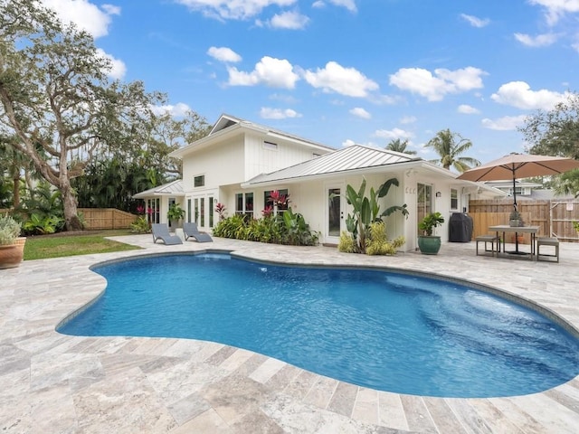 view of pool featuring a patio area and french doors