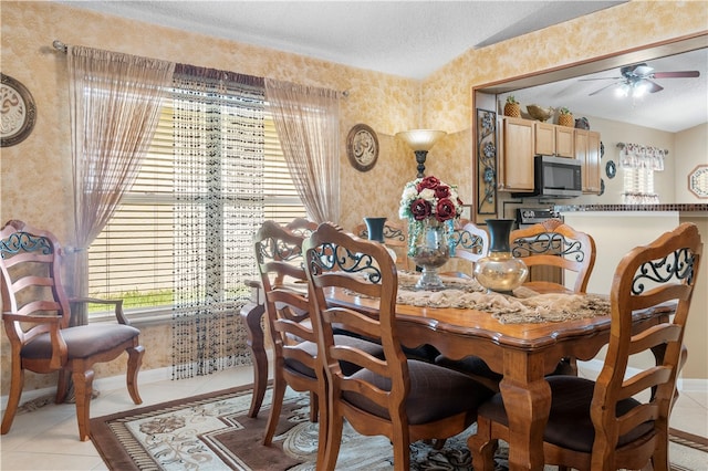 dining area featuring ceiling fan, a textured ceiling, and light tile patterned flooring