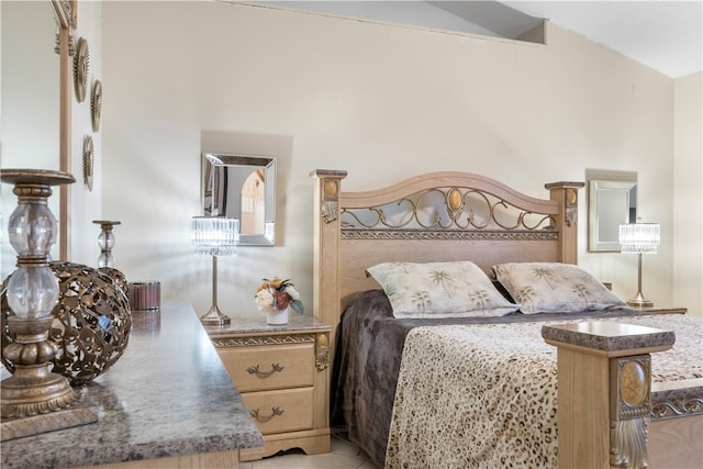 tiled bedroom featuring vaulted ceiling