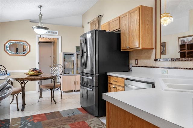 kitchen with stainless steel appliances, vaulted ceiling, hanging light fixtures, light tile patterned floors, and backsplash