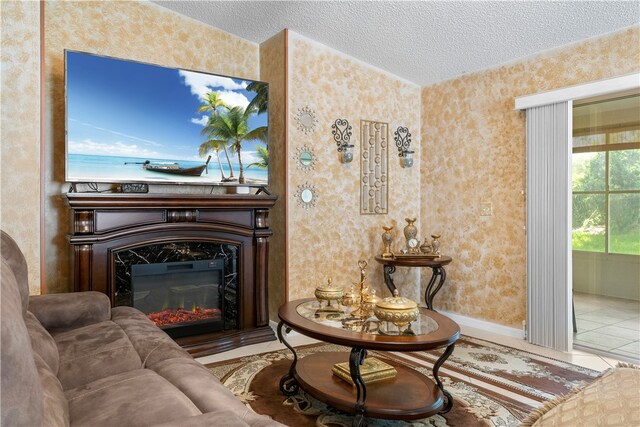 sitting room featuring a premium fireplace and a textured ceiling