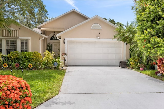 view of front of house with a garage and a front lawn