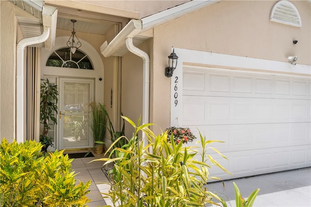 view of exterior entry with a garage